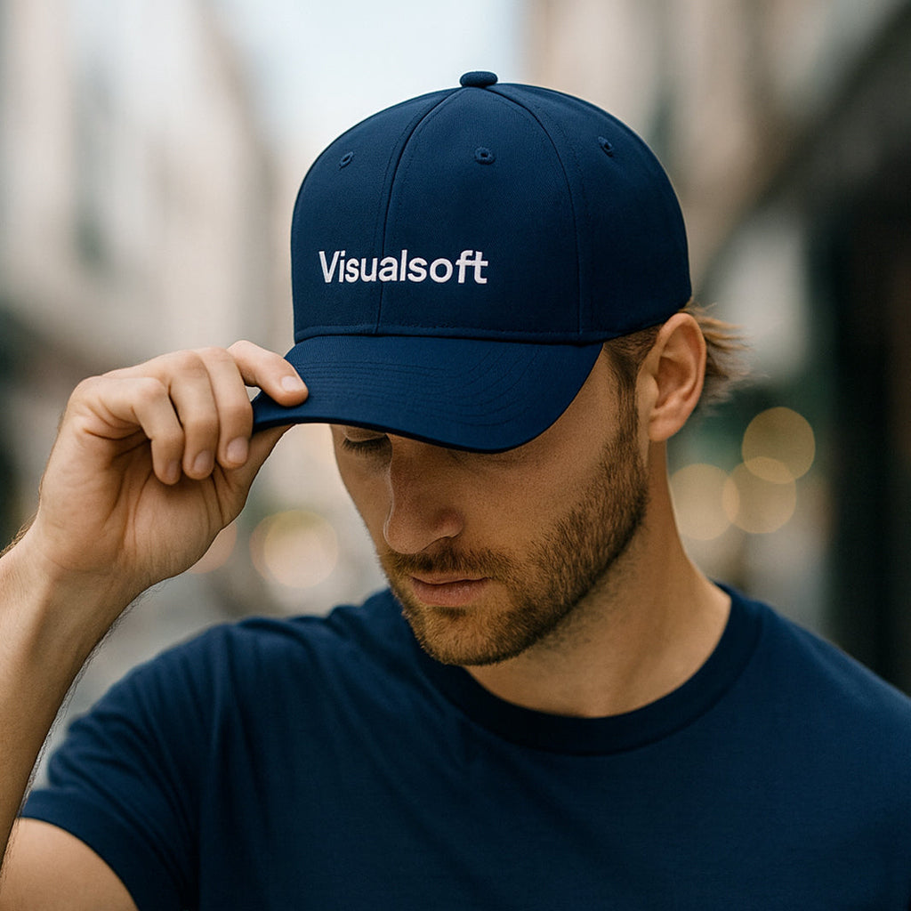 Man wearing a navy blue Visualsoft branded baseball cap and matching t-shirt.