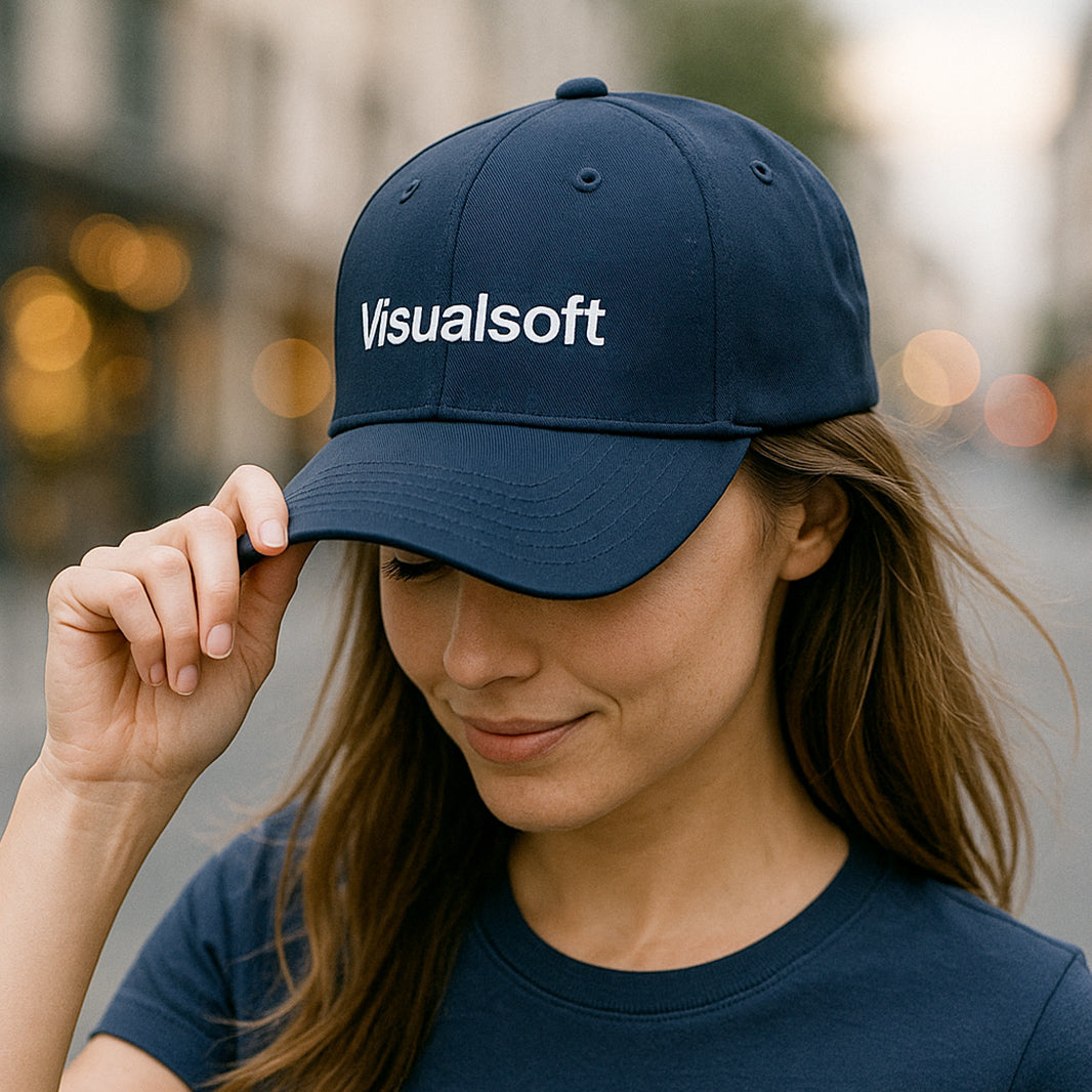 Woman wearing a navy blue baseball cap with Visualsoft logo and matching t-shirt.