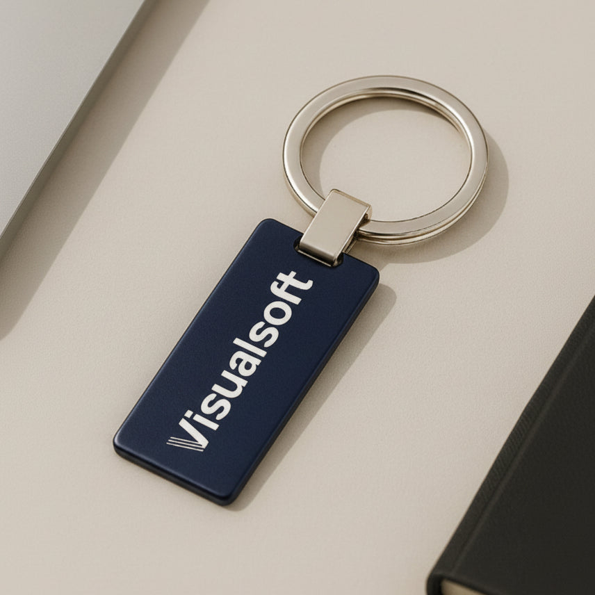 A navy blue rectangular keychain with the word Visualsoft in white text, attached to a silver keyring.